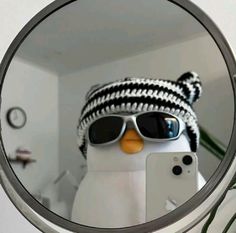 a mirror with a snowman wearing sunglasses and a knitted hat