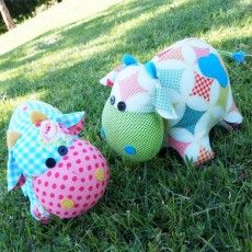 two stuffed animals sitting in the grass