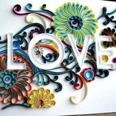 the word love is made up of colorful flowers and swirls on white card with yellow ribbon