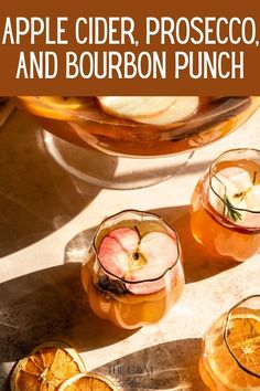 apple cider, proseco and bourbon punch on a table with sliced oranges