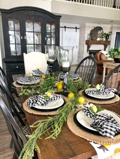 a dining room table with plates and place settings