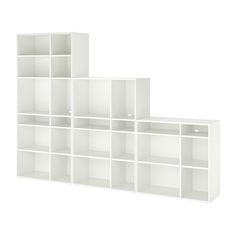 three white bookshelves are stacked on top of each other, one is empty