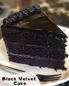 a slice of black velvet cake on a white plate