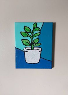 a painting of a potted plant on a blue and white background, hanging on the wall