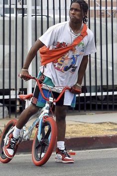 a man riding a bike down the street