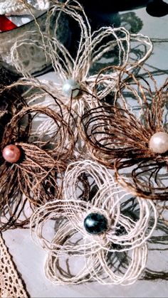 several pieces of wire and pearls on a table