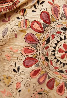 closeup of an embroidered fabric with floral designs