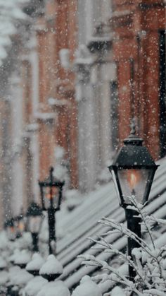 a street light covered in snow next to buildings