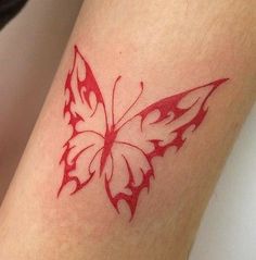 a small red butterfly tattoo on the arm and leg, it looks like something out of a fairy tale