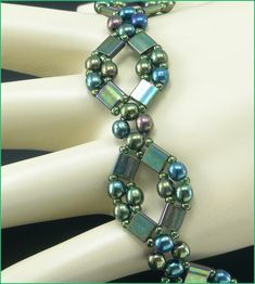 a bracelet made with pearls and glass beads on a mannequin's head