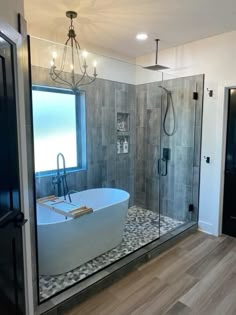 a bathroom with a large tub and walk in shower