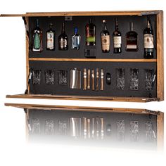 a wooden case with liquor bottles and glasses in it