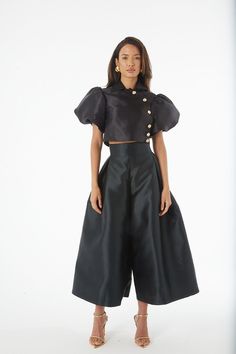 An artful mix between Culottes and a skirt, these Culottes are a dramatic statement piece, mixing a sharp, high waist and wide leg, with an elegant and unusual pleated detail at the front - the look of a skirt in a trouser. Fit - Fits true to size. Take your normal size. Voluminous Skirt For Spring Party, Spring Party Full Skirt Bottoms, Glamorous Satin Bottoms For Evening, Spring Satin Party Bottoms, Summer Party Satin Bottoms, Spring Party Satin Bottoms, Spring Satin Full Skirt Bottoms, Black Satin Party Bottoms, Satin Trousers For Party