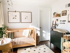 a baby's room with white walls and wooden furniture