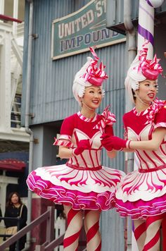 two women dressed in pink and white are dancing