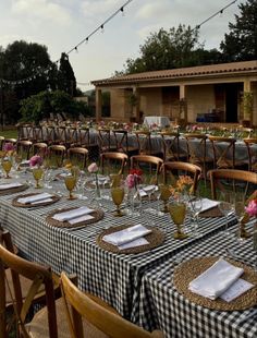 an outdoor dining area with tables and chairs set up for a formal dinner or party