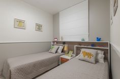 two twin beds in a small room with white walls