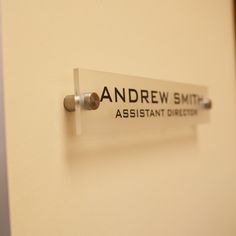 a sign on the wall that says andrew smith assistant directors's desks