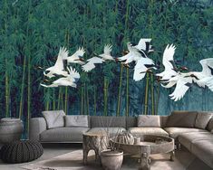 a living room filled with lots of white birds flying over bamboo trees