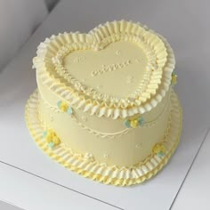 there is a three layer cake that has been decorated with flowers and the word love on it