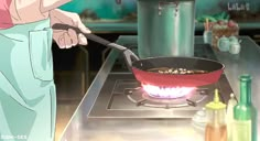 a person cooking food in a frying pan on top of an open burner