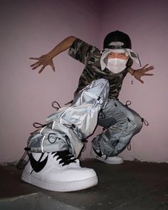 a man in camouflage is doing tricks on his skateboard while wearing white and black sneakers