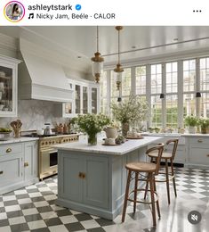 an image of a kitchen setting with checkered flooring and white cabinets on the walls