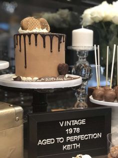 a table topped with cakes and desserts covered in frosting