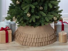 Natural-looking burlap tree collar with 3 tiered ruffles is a festive addition to any Christmas tree. Simply insert one tube into the elastic bands at the bottom forming a circular base and do the same with the other tube at the top of the tree collar. Stand band has a 26 inch diameter at the base, and approximately 18.5 inch diameter at the top which accommodates most live and artificial Christmas tree stands and bases.. New Traditions 26-in Brown/Tan Tree Collar Tree Skirt | 2266101-3DD Christmas Tree In Basket, Artificial Christmas Tree Stand, Christmas Tree Stands, Burlap Tree, Christmas Tree Collar, Cardboard Christmas Tree, Holiday Tree Skirts, Band Christmas, Burlap Christmas Tree