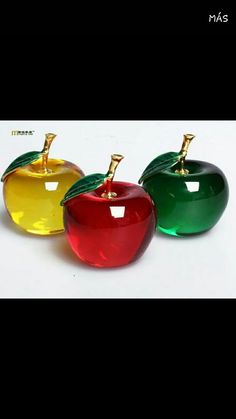 three different colored apples sitting next to each other