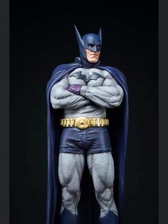 the batman statue is posed with his arms crossed