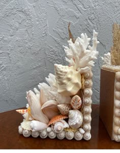 two vases with seashells and shells in them