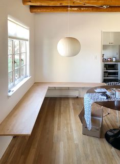 an empty room with wooden floors and white walls