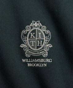 the logo for williamburg brooklyn is shown in white on a dark green shirt with an ornate design