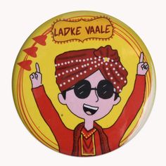 a button with an image of a person wearing sunglasses and a bandana on it