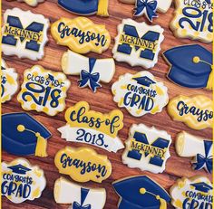 decorated cookies with graduation caps and tassels are displayed on a wooden table top