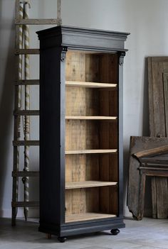 an old fashioned bookcase with wooden shelves