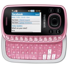 a pink and white cell phone sitting on top of a table