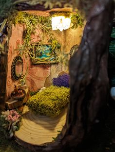 a miniature garden is shown in the shape of a house with moss growing on it's walls