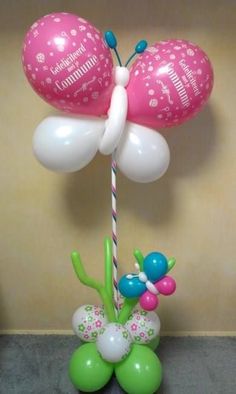 balloon bouquet in the shape of a butterfly with two balloons attached to it's head