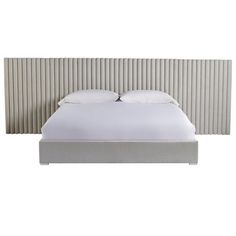 a bed with white sheets and pillows in front of a headboard made out of metal strips