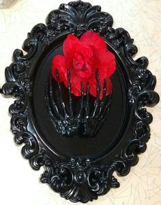 a black plate with red flowers in it