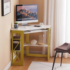 a computer monitor sitting on top of a desk next to a book shelf and chair