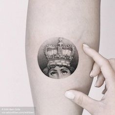 a woman with a crown tattoo on her arm