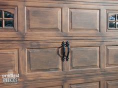 a close up of a wooden garage door with glass inserts on the top and bottom