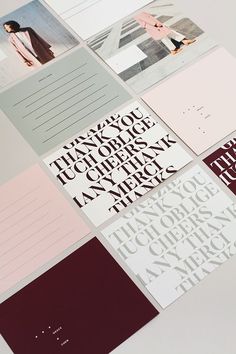 several different types of stationery on a white surface with red and pink papers in the middle