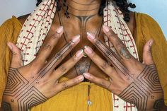 a woman with tattoos on her hands and chest