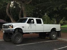 a white pickup truck parked in a parking lot