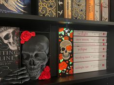 there are many books on the shelves with skulls and roses painted on each bookcase