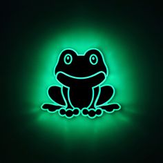 a lit up frog sitting in the dark